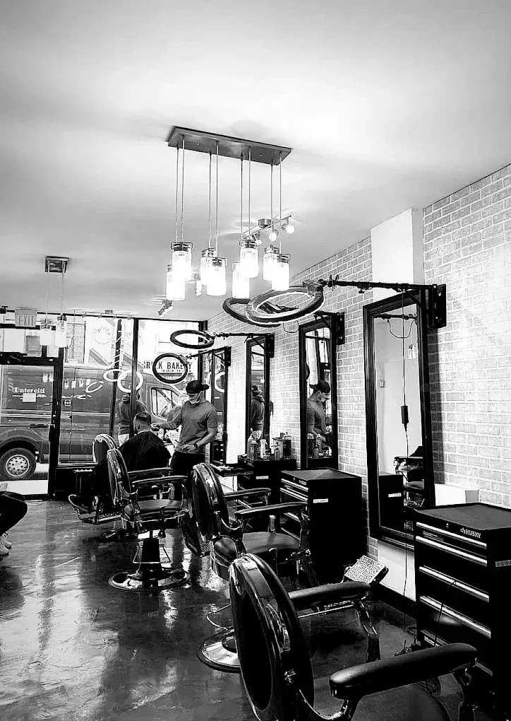 Barber chairs and mirrors inside Wolvesden on Pape Avenue